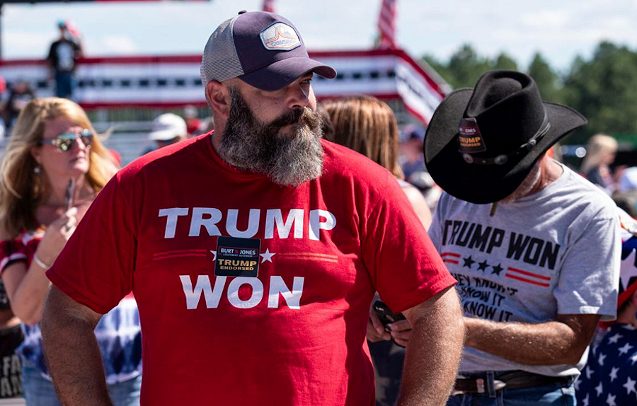 Fan at Trump Rally Perry GA wearing a bright red Trump Won t-shirt. 